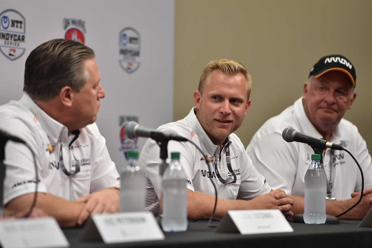 Arrow McLaren SP team president Taylor Kiel (center) discusses the team's acquisition by McLaren Racing with McLaren Racing CEO Zak Brown (left) and Arrow Electronics CEO Mike Long (right).