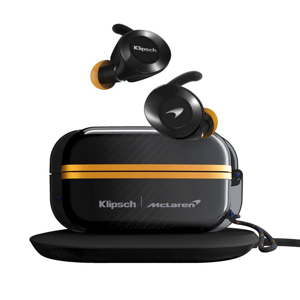 Klipsch McLaren F1 Edition wireless earbuds and charging case on charging mat