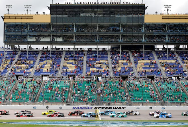 A limited number of fans watch the start of a NASCAR Cup Series car race at Kansas Speedway in Kansas City, Kan., Sunday, May 2, 2021.