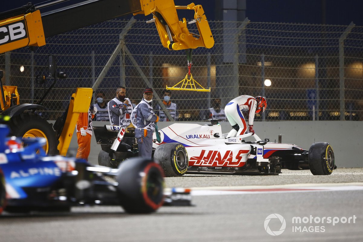 Nikita Mazepin, Haas VF-21, climbs out of his car after a crash on the opening lap