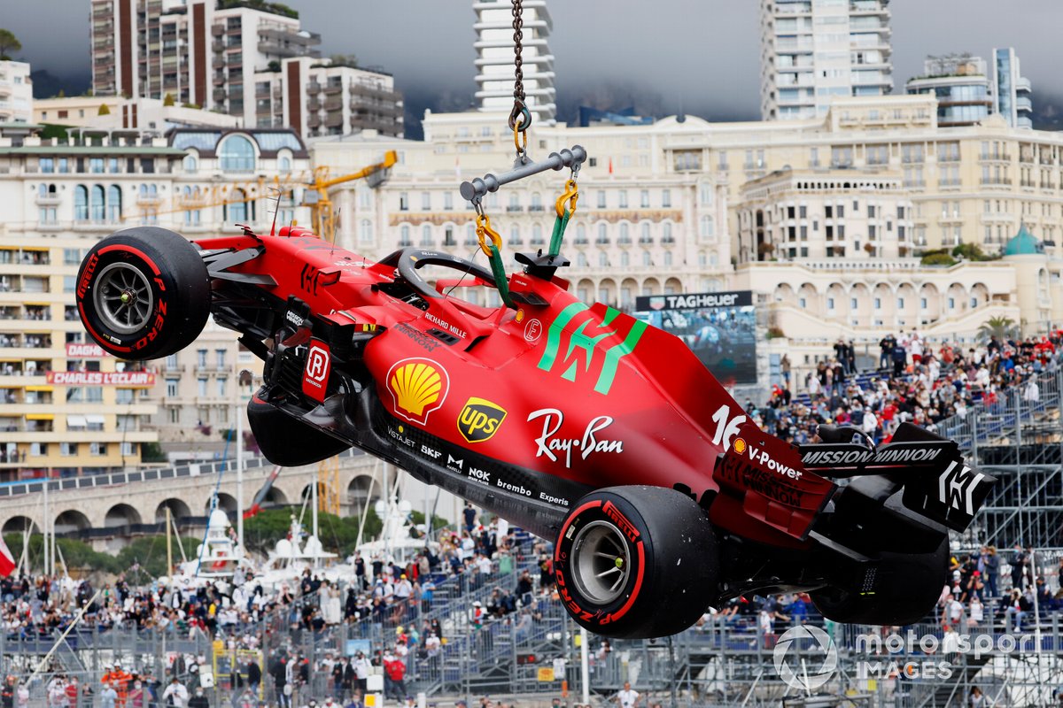 The car of Charles Leclerc, Ferrari SF21, is craned away