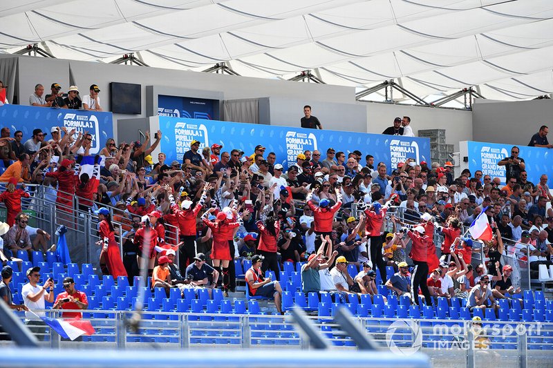 A French Grand Prix promotion team among the fans in a grandstand