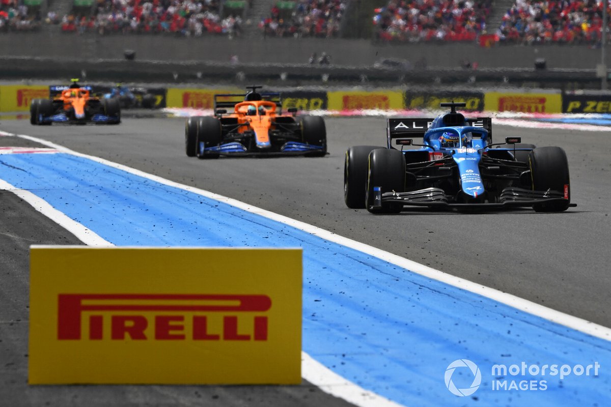 Fernando Alonso, Alpine A521, leads Daniel Ricciardo, McLaren MCL35M, and Lando Norris, McLaren MCL35M