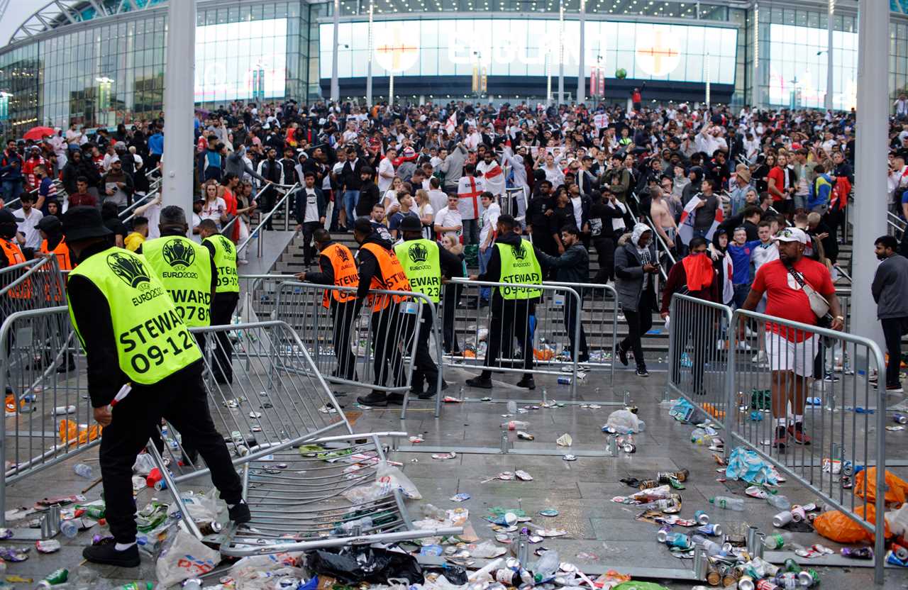 Stewards replace barricades after being knocked down outside Wembley in the Euro Finals