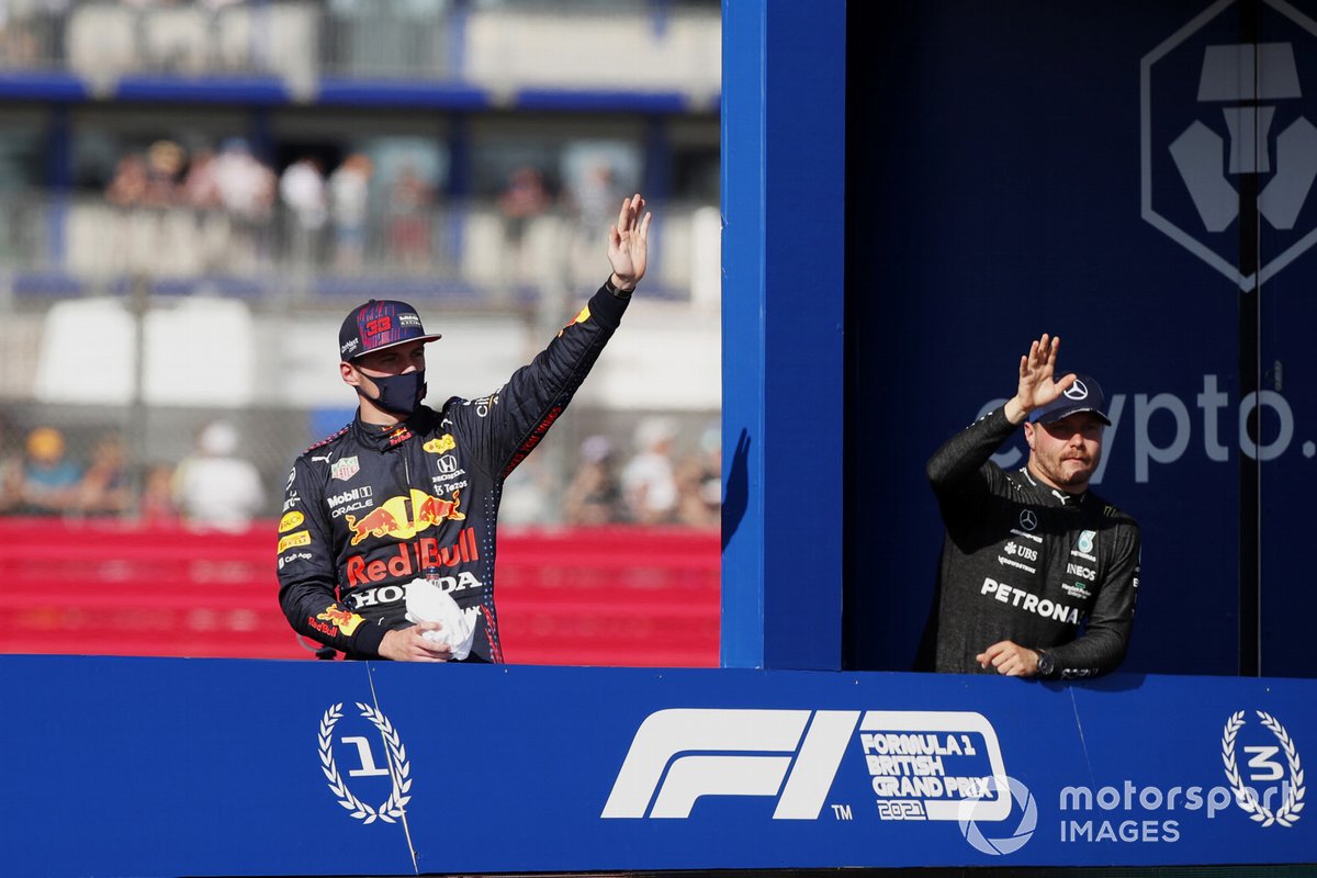 Max Verstappen, Red Bull Racing, 1st place, and Valtteri Bottas, Mercedes, 3rd place, drive across the track in the lap truck after the sprint qualifying