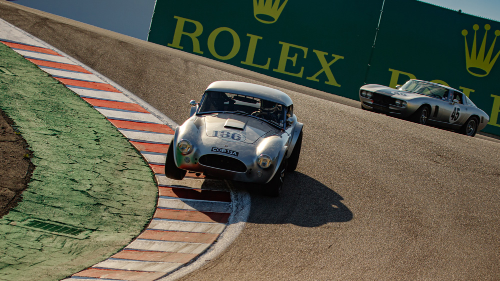 A 1964 Shelby Cobra 289 dances on the Corkscrew at WeatherTech Raceway Laguna Seca during the 2021 Rolex Monterey Motorsports Reunion.