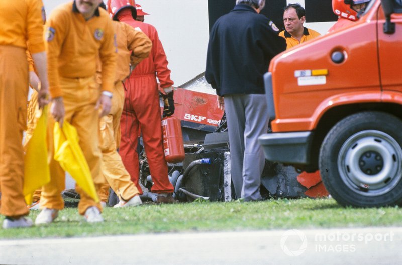 Marshals visit Gerhard Berger's Ferrari 640 after an accident