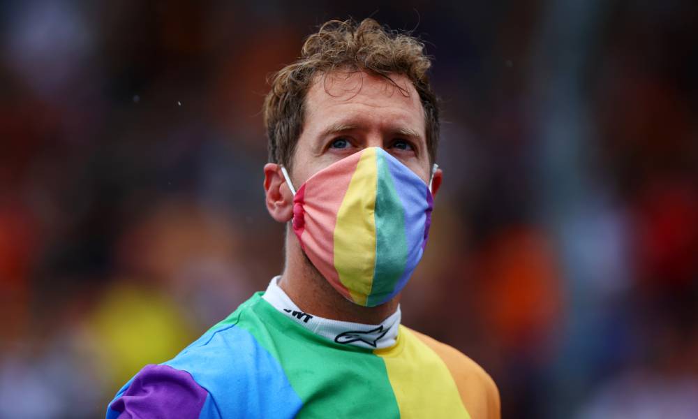 Sebastian Vettel wears a rainbow coloured shirt and face mask at the F1 Grand Prix of Hungary