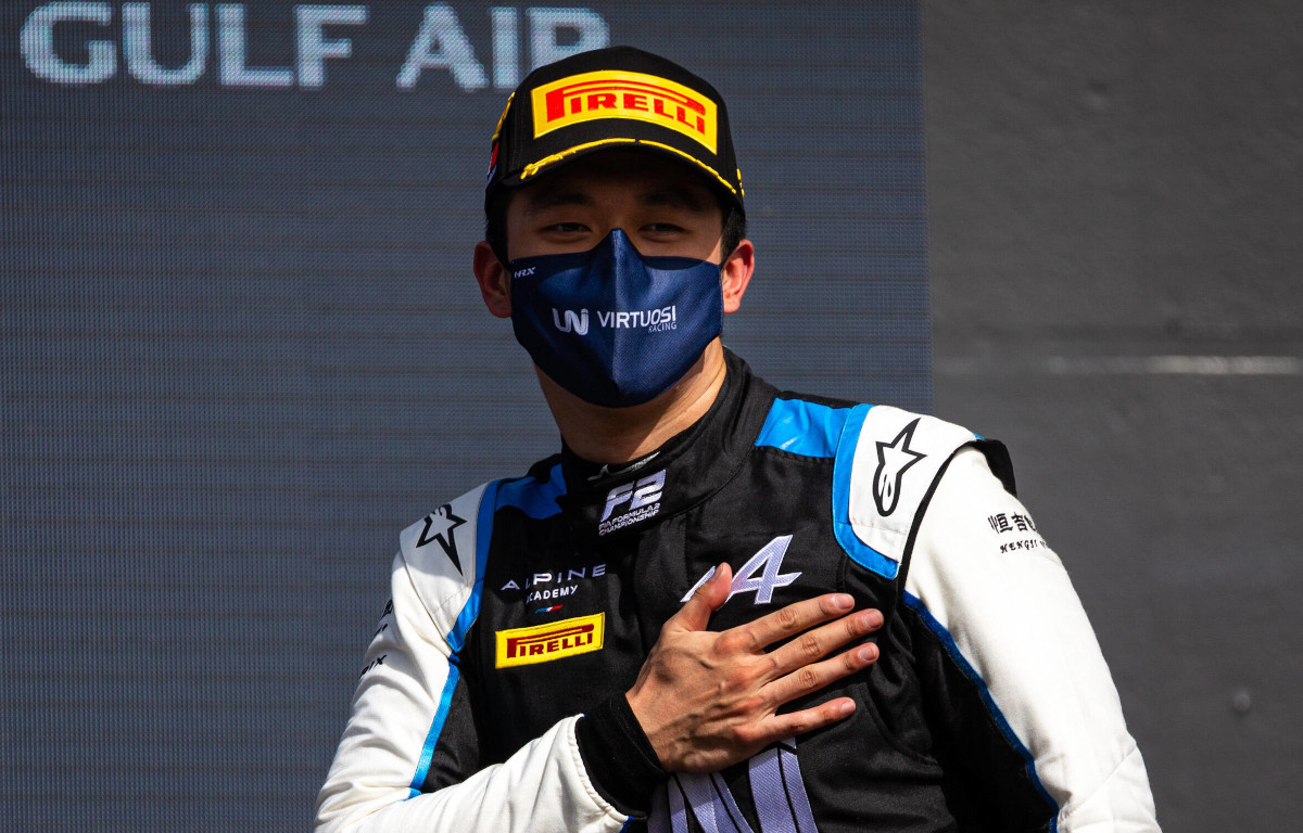 Guanyu Zhou stands with his hand on his heart.  Bahrain March 2021