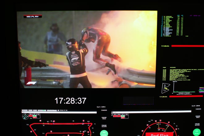BAHRAIN, BAHRAIN - NOVEMBER 29: Romain Grosjean of France and Haas F1 are pictured on a screen escaping his crash during the Bahrain F1 Grand Prix at the Bahrain International Circuit on November 29, 2020 in Bahrain, Bahrain. (Photo by Peter Fox / Getty Images)