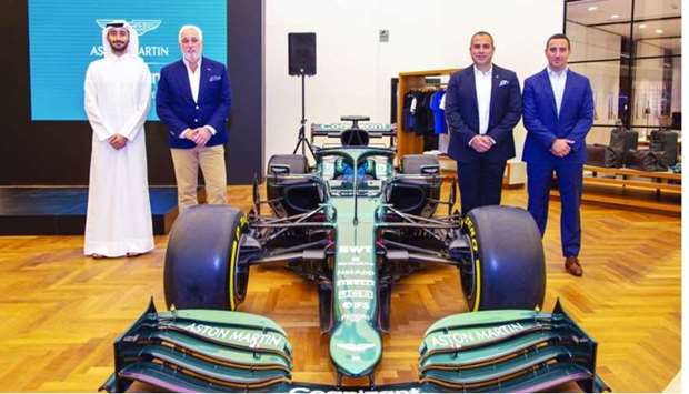 Aston Martin Lagonda executive chairman Lawrence Stroll and ALM team flank Aston Martin F1 Show Car