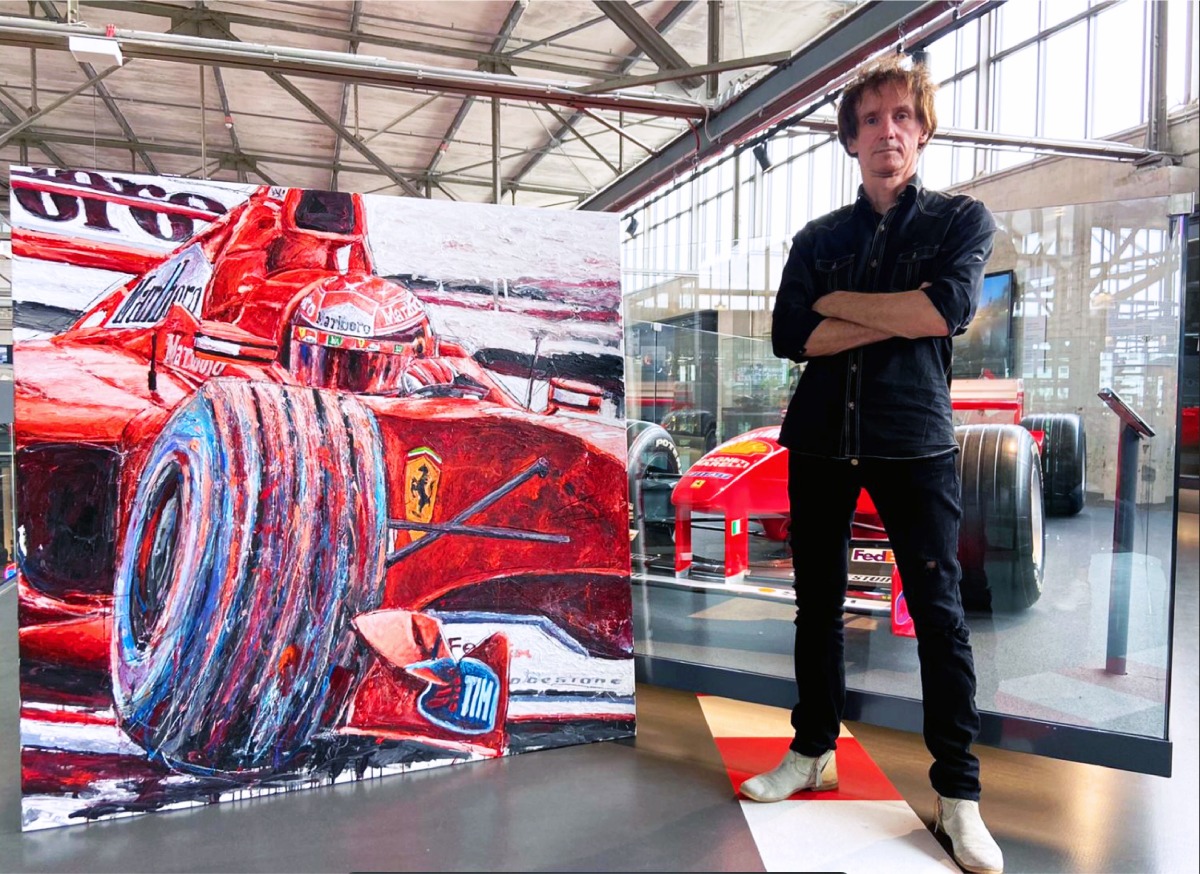 Renowned painter and official artist of Formula 1, Armin Flossdorf, with his artworks.
