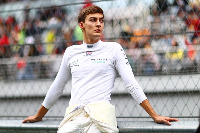 George Russell of Great Britain and Williams looks on from the grid before the F1 Grand Prix of Russia at Sochi Autodrom on September 26, 2021 in Sochi, Russia.
