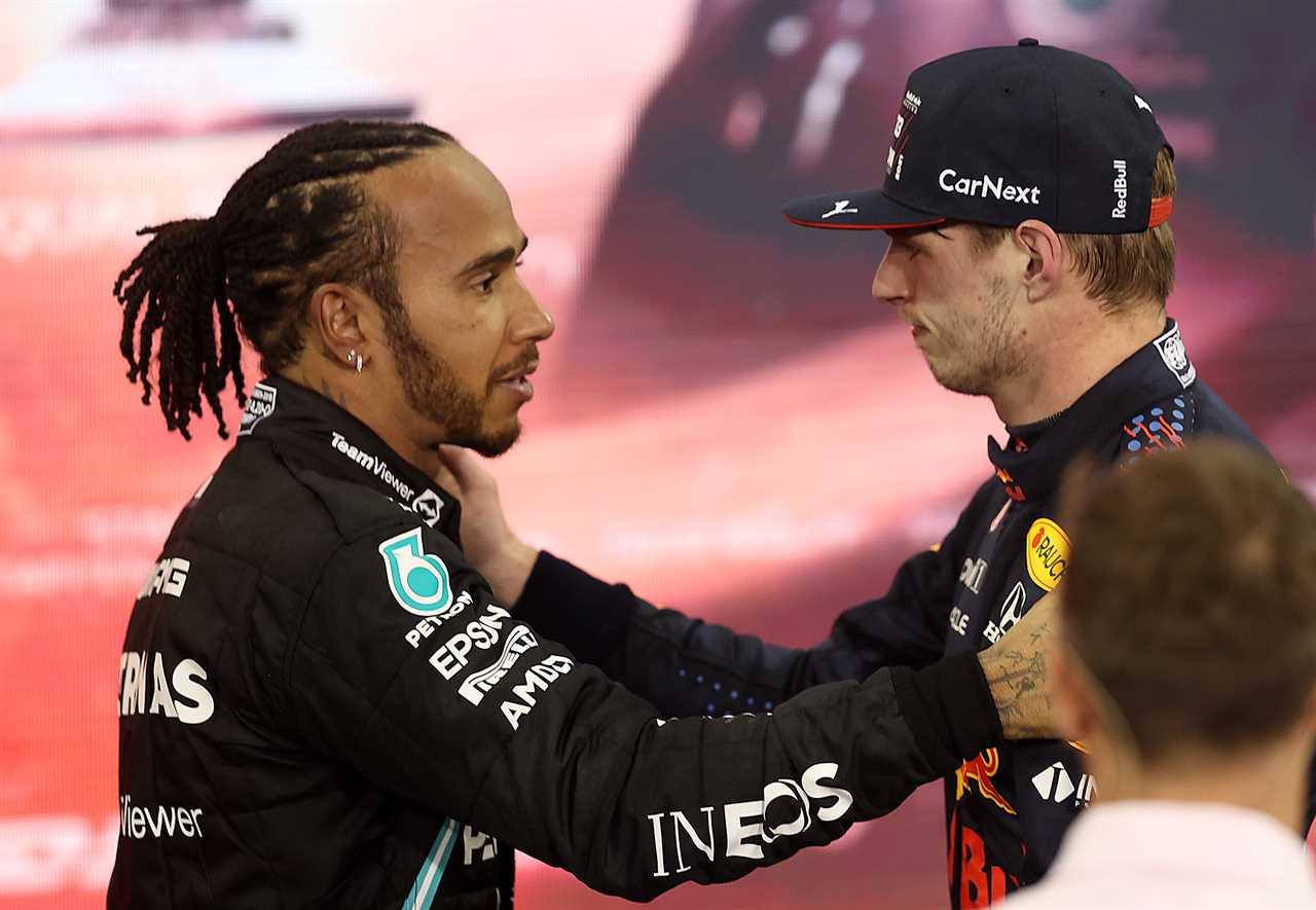 Two racing drivers hug after a hard-fought race.