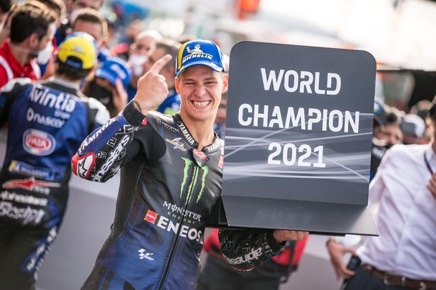 Quartararo holds up a sign indicating that he has become a MotoGP World Champion