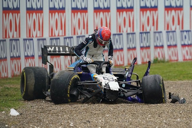 George Russell getting out of his stricken Williams F1 car.