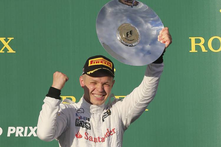 McLaren driver Kevin Magnussen of Denmark holds up his trophy in celebration after finishing third in the Australian Formula One Grand Prix at Albert Park in Melbourne, Australia, Sunday, March 16, 2014. Mercedes driver Nico Rosberg of Germany won the race.  (AP Photo/Rob Griffith)