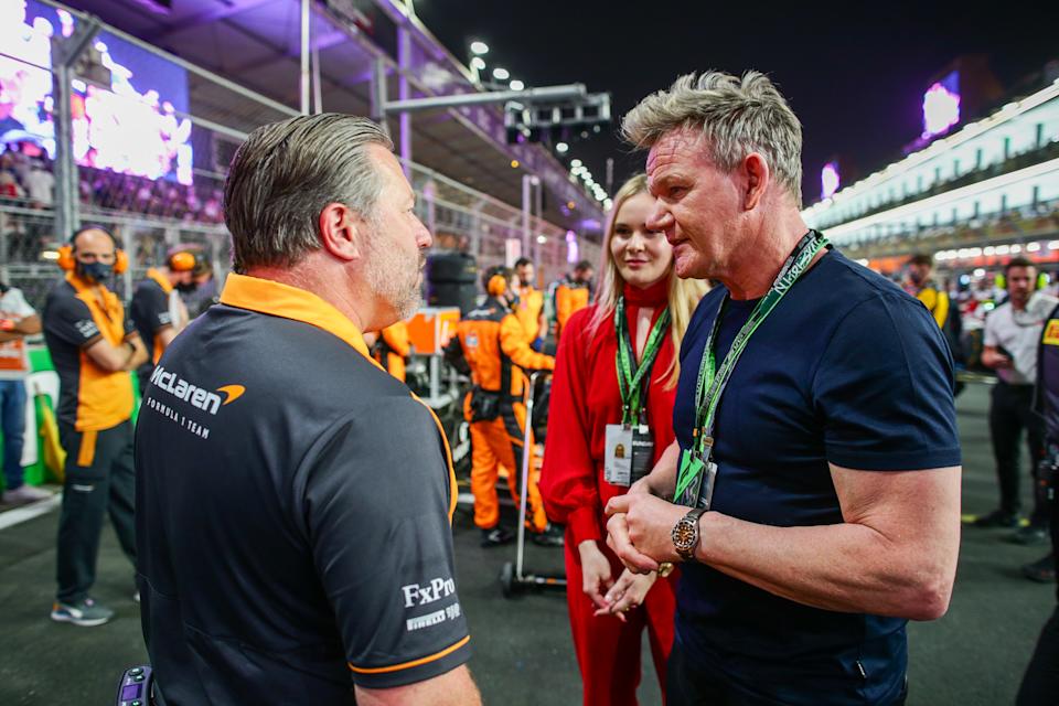 JEDDAH, SAUDI ARABIA - MARCH 27: Gordon Ramsey of Great Britain chats with Zak Brown of McLaren and USA during the F1 Grand Prix of Saudi Arabia at the Jeddah Corniche Circuit on March 27, 2022 in Jeddah, Saudi Arabia.  (Photo by Peter J Fox/Getty Images)