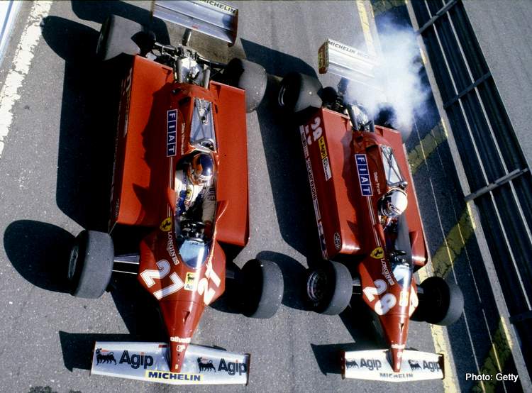 Gilles Villeneuve #27 and Didier Pironi #28 side by side in the pit lane aboard their Scuderia Ferrari 126CK Ferrari V6s before the start of the San Marino Grand Prix on 3rd May 1981 at the Autodromo Enzo e Dino Ferrari in Imola, San Marino.  (Photo by Grand Prix Photo/Getty Images)