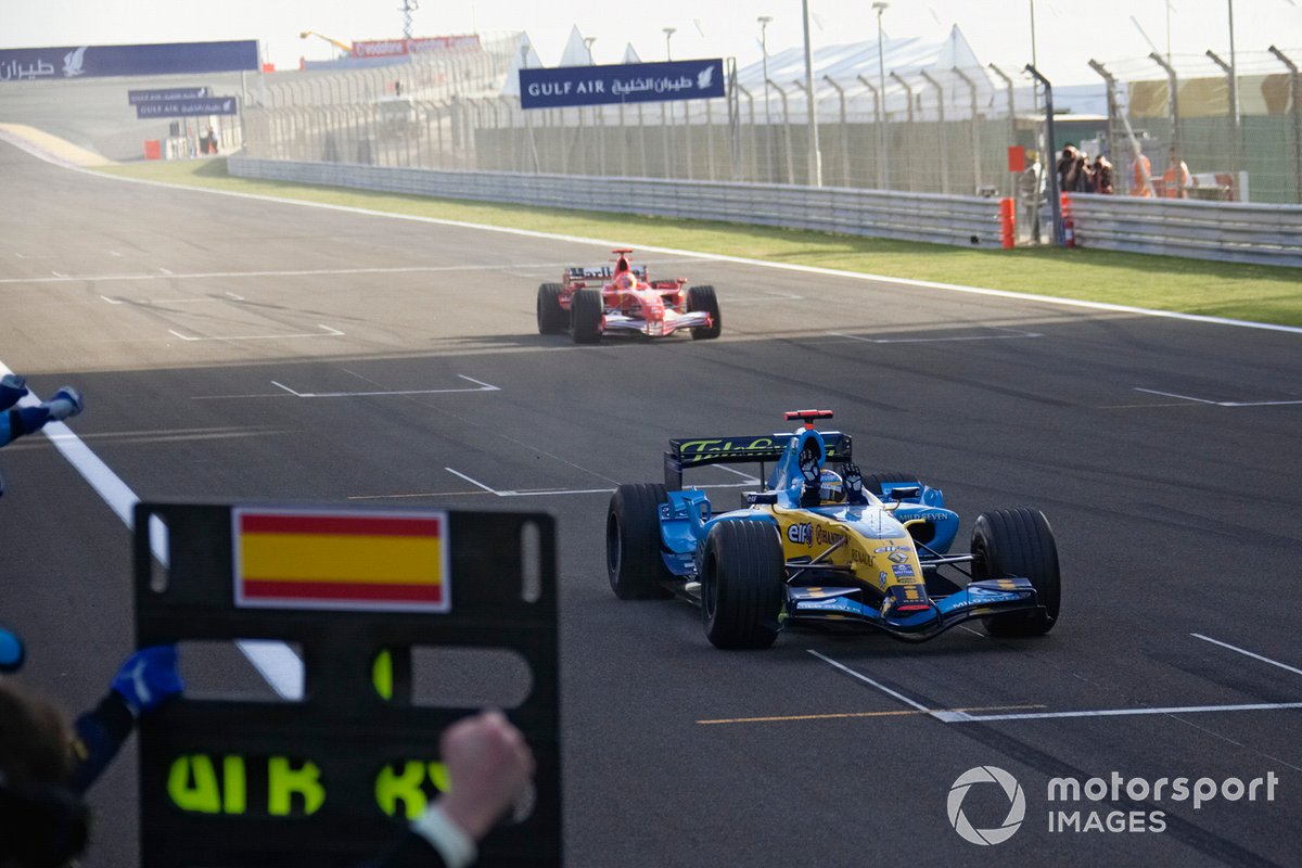 Fernando Alonso, Renault R26 claims victory ahead of Michael Schumacher, Ferrari 248 F1