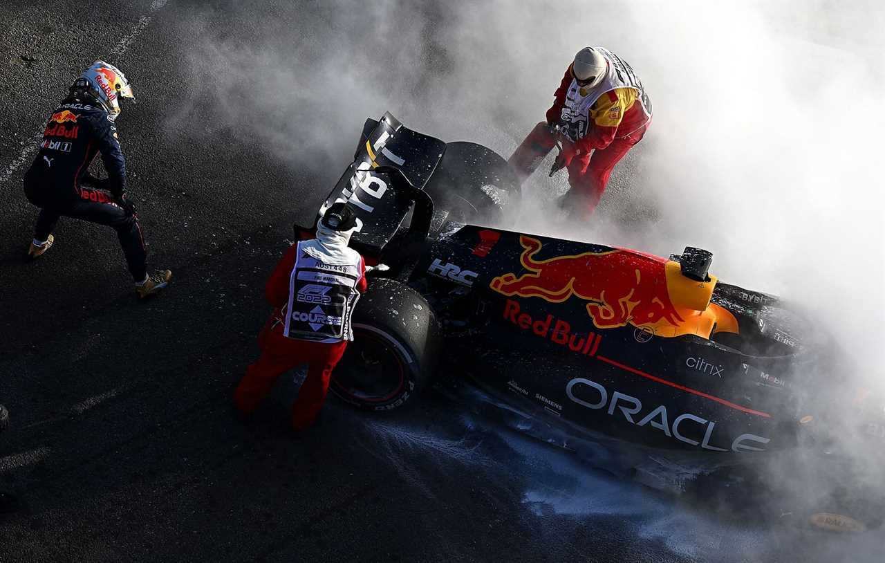 Max Verstappen (left) watches on as marshals douse the flames from his Red Bull RB18 during the 2022 F1 Australian GP. (Photo by Clive Mason/Getty Images)