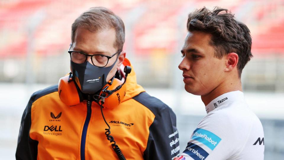 Lando Norris standing next to Andreas Seidl.  Barcelona February 2022. Credit: PA Images