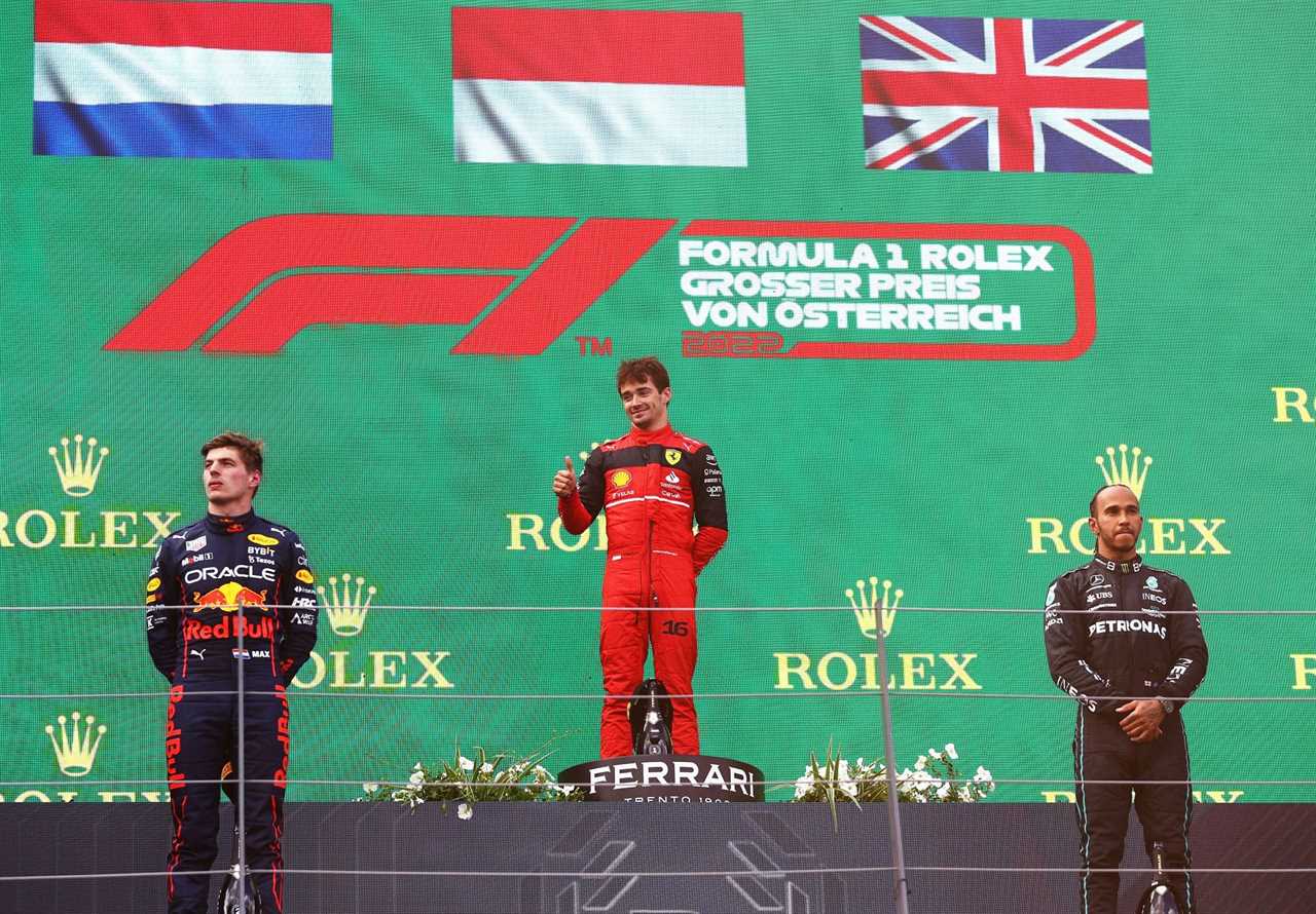 (From L to R) Red Bull's Max Verstappen, Ferrari's Charles Leclerc, and Mercedes' Lewis Hamilton on the podium at the 2022 F1 Austrian GP (Photo by Clive Rose/Getty Images)