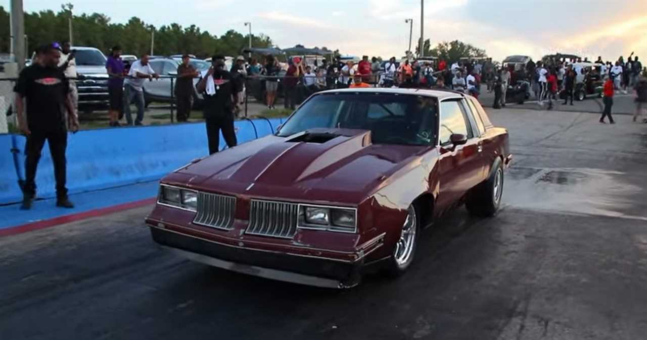 Oldsmobile Cutlass Drag Racer, red, front quarter view on drag strip