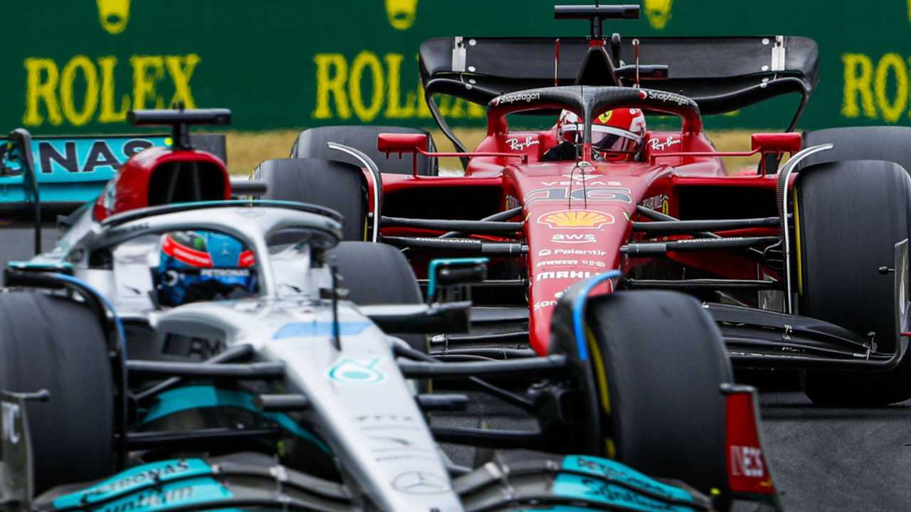 George Russell slightly blurred leads Charles Leclerc.  HungaryJuly 2022