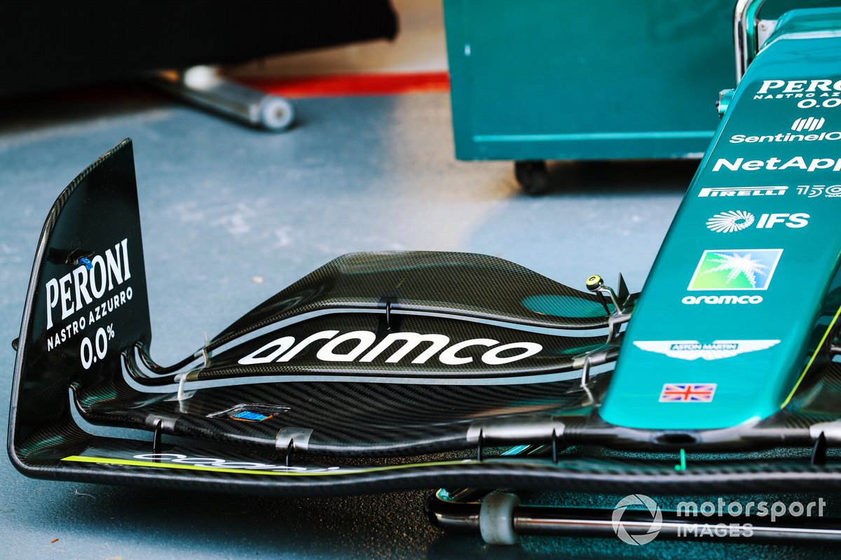 The nose and front wing of an Aston Martin AMR22 in the pit lane