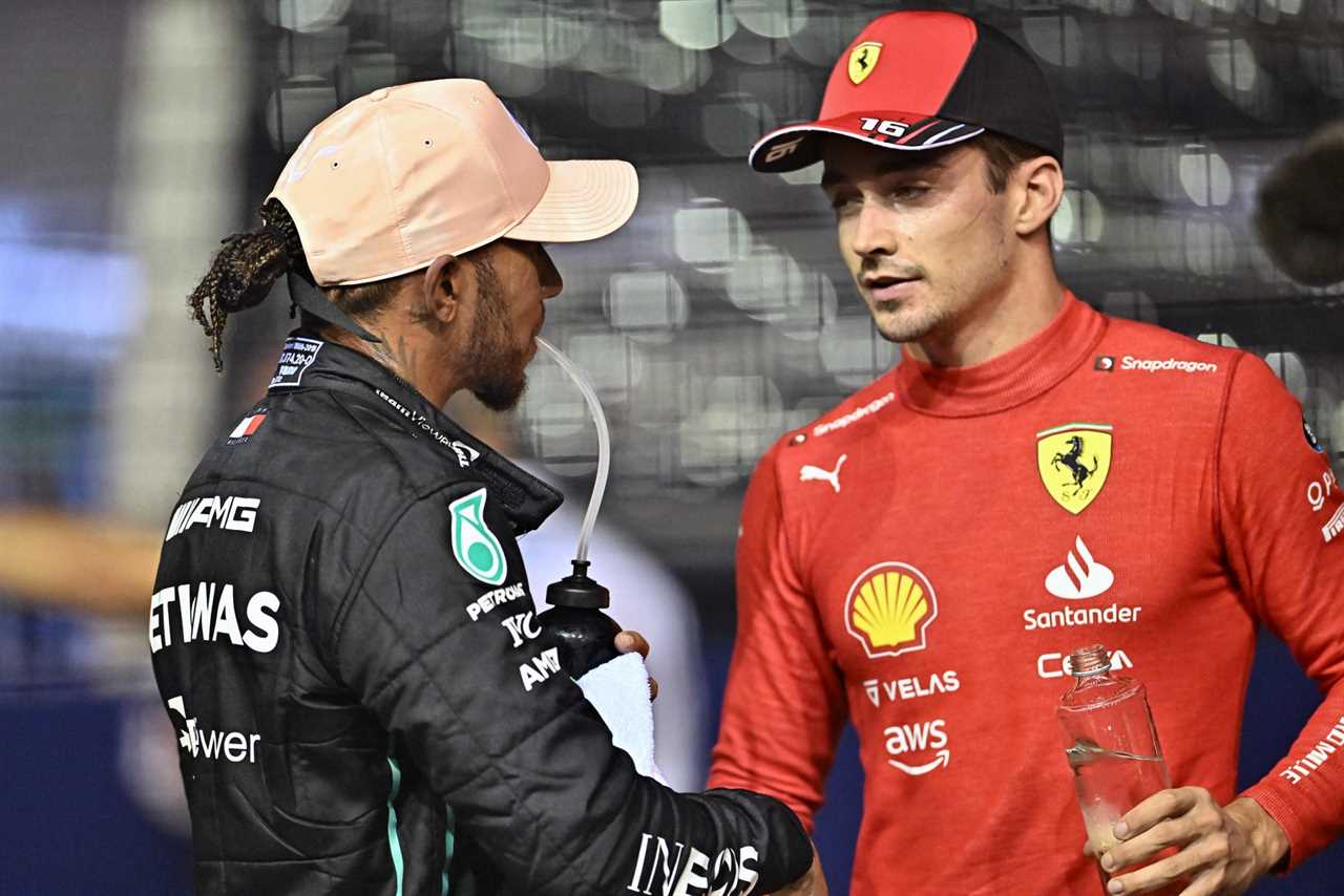 Mercedes' British driver Lewis Hamilton (L) greets Ferrari's Monegasque driver Charles Leclerc (R) after the qualifying session ahead of the Formula One Singapore Grand Prix night race at the Marina Bay Street Circuit in Singapore on October 1, 2022. (Photo by Lillian SUWANRUMPHA / AFP) (Photo by LILLIAN SUWANRUMPHA/AFP via Getty Images)