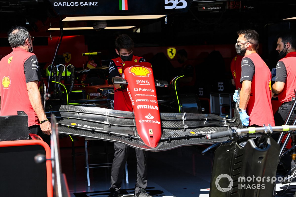 Ferrari mechanics carry a nose cone