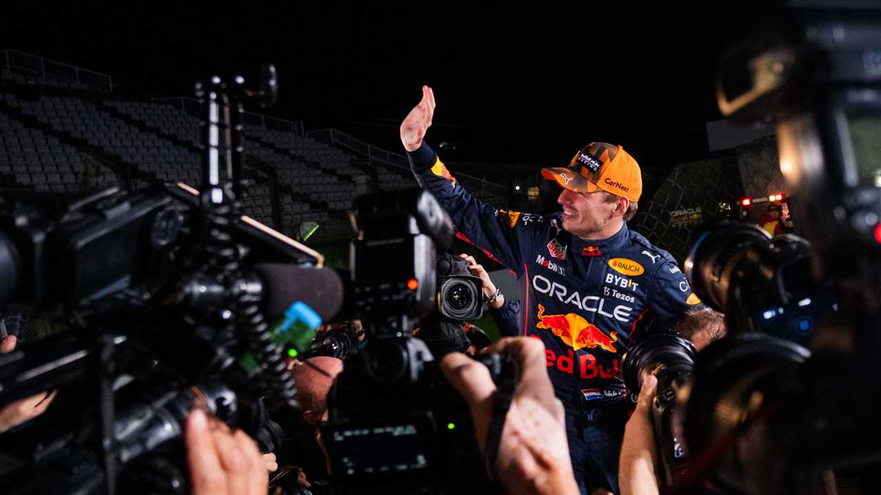 Max Verstappen waving as he is surrounded by photographers. Japan October 2022